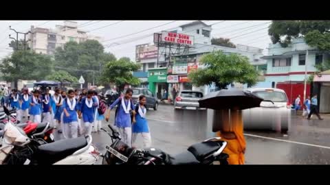 Indian School girl's enjoy rainy weather in street