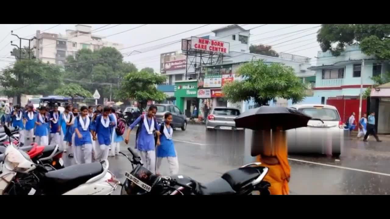 Indian School girl's enjoy rainy weather in street