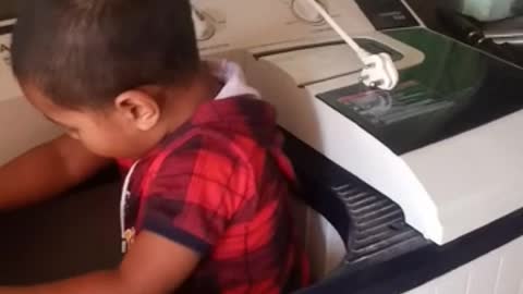 Cute baby playing in washing machine randomworld.