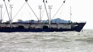 Huge container ships sailing away to the sea