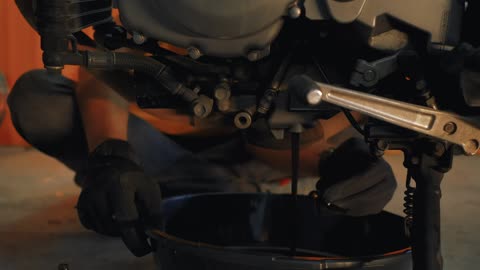 Mechanic repairing a motorcycle engine