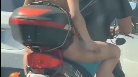 Saving her legs while riding a motorbike