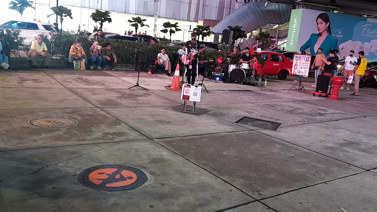 Young boy, on the side of the road, singing a beautiful English song, Malaysia, Bukit Bintang