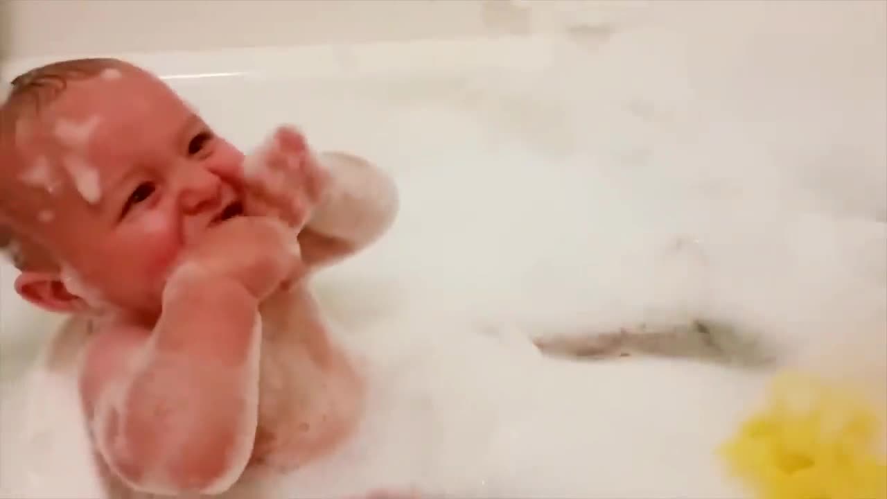 Baby laughing and playing in shower