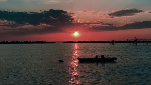 Silhouette of a Boat on Beach Shore During Golden Hour