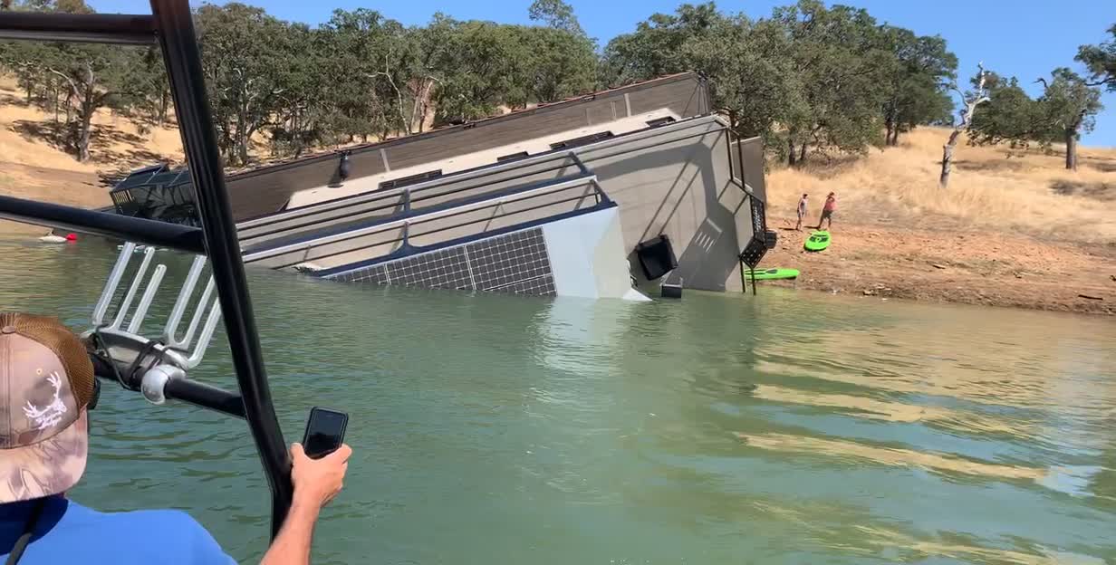 Large Boat Tips and Sinks Near Shore