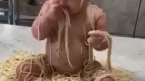 baby eating noodles