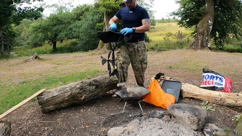 Packing away the portable firepit. Riverside.