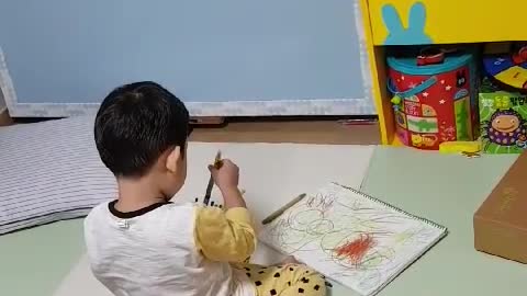 This is a baby who is obsessed with drawing.