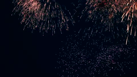 Flashing fireworks in the night sky