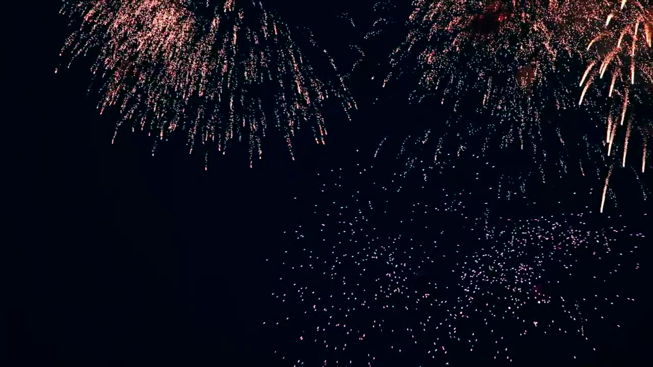 Flashing fireworks in the night sky