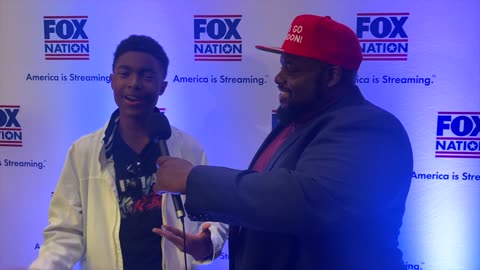 Ron J Spike speaking with Musician Chandler Crump about his Rising Music Career at AmericaFest 2021