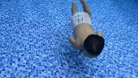 small child swimming