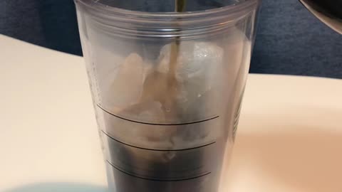 Pouring coke into a cup of ice