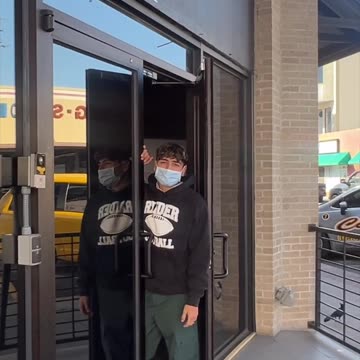 An NGO female is carrying a Covid 19 plastic bag to the . Catholic Charities RGV facility