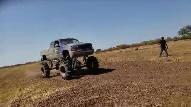 Monster truck hammers camera guy with rocks and dirt