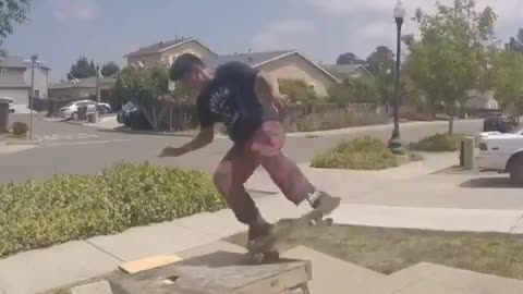 Nsfw black t-shirt kid falls of skateboard grinding on sidewalk