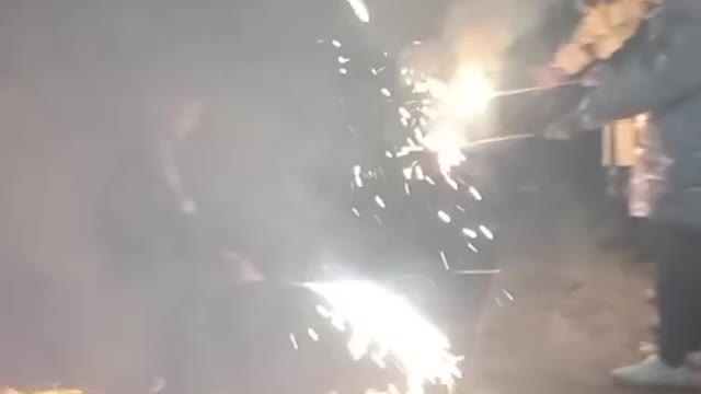 Relatives and friends set off fireworks at night