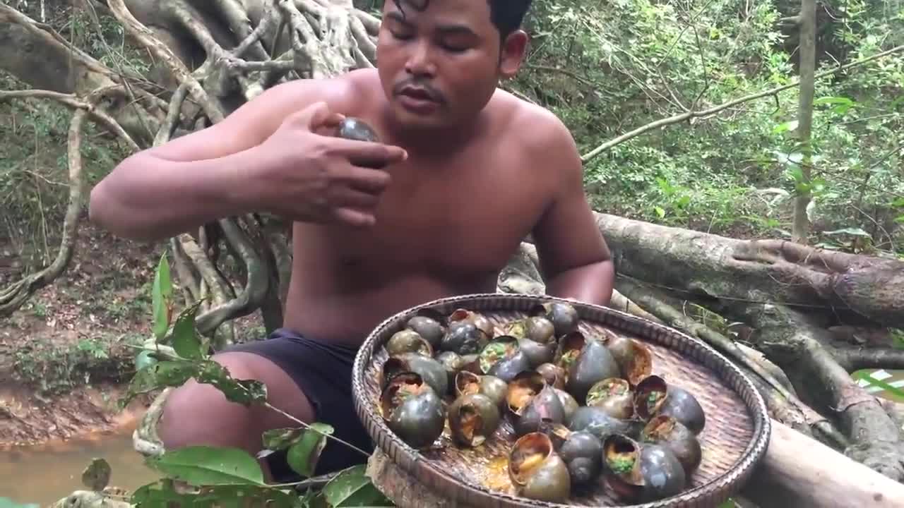 Primitive Man Entering the Forest and Gathering African Snails and Eating