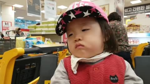 A baby sleeping on a shopping cart