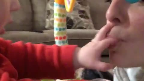 Baby plays and scratches moms lips