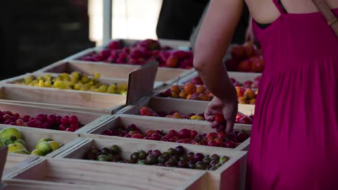 A woman choosing fruit at a market