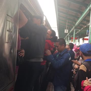 People in asia cram climb into subway car