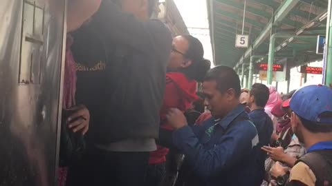 People in asia cram climb into subway car