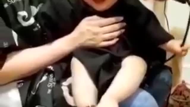 Baby laughing while cut of his hair