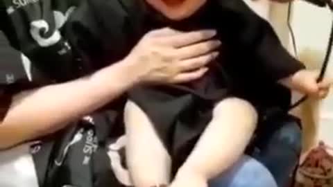 Baby laughing while cut of his hair