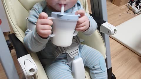 The baby is eating his first milk