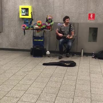 Guy striped shirt singing somewhere over the rainbow green bowls next to him