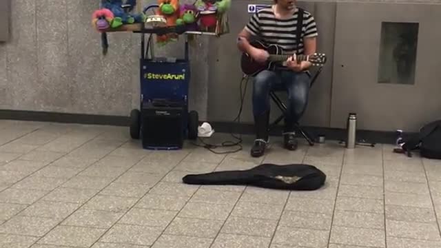 Guy striped shirt singing somewhere over the rainbow green bowls next to him