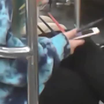 Blue jacket sweater girl subway phone long nails