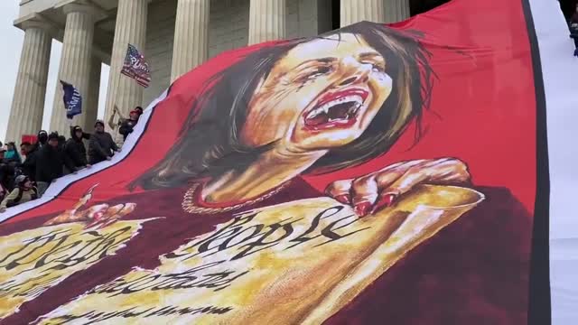 Trump Supporters Unfurl Giant Flag Of Nancy Pelosi Ripping The Constitution