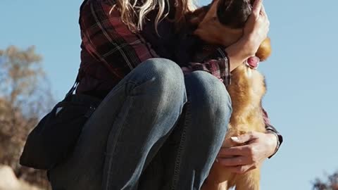 A Woman Kissing a Dog