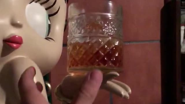 Guy knocks over alcohol in hand of betty boop statue