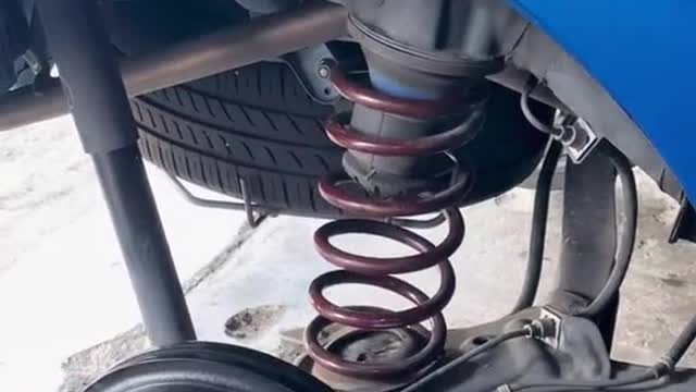 The car repairman installs the shock spring process