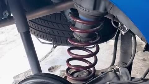 The car repairman installs the shock spring process