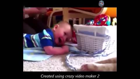 baby plays with cat