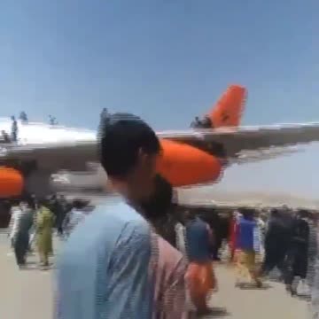 Afghans still climbing on aircraft at Kabul airport knowing it's almost certain instant death.