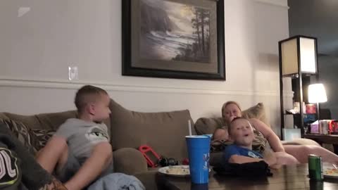 kids get scared when dad pranks them by screaming while watching tv