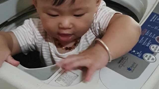 The 5-month-old baby was playing in the drum of the washing machine.
