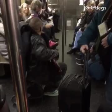 Black jacket guy plays bass and sings on subway