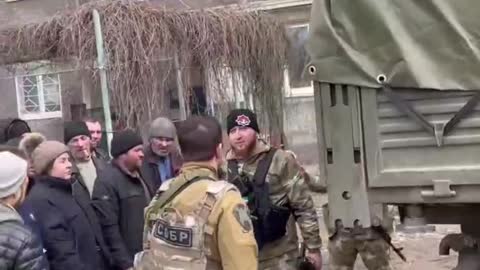 Chechen soldiers distribute humanitarian aid in Mariupol