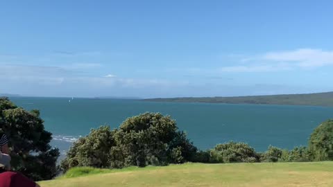 Hill in New Zealand with a view of the sea