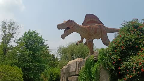 The dinosaur stood on the hill and watched