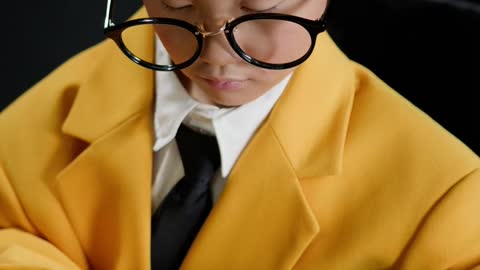 Child in a Yellow Suit Typing on a Typewriter!