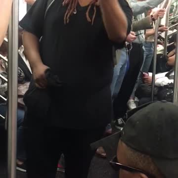 A man in orange shoes sings on subway train