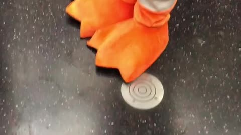 Person dressed as pigeon with tie orange feet